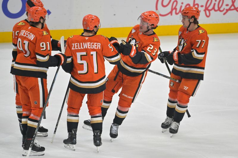 Nov 5, 2024; Anaheim, California, USA; Anaheim Ducks defenseman Olen Zellweger (51) is congratulated after scoring a goal in the first period against the Vancouver Canucks at Honda Center. Mandatory Credit: Jayne Kamin-Oncea-Imagn Images