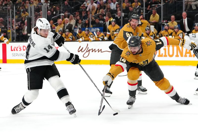 Oct 22, 2024; Las Vegas, Nevada, USA; Los Angeles Kings right wing Alex Laferriere (14) shoots against the stick check of Vegas Golden Knights defenseman Nicolas Hague (14) during the first period at T-Mobile Arena. Mandatory Credit: Stephen R. Sylvanie-Imagn Images