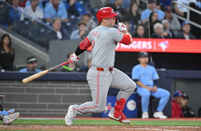 Aug 19, 2024; Toronto, Ontario, CAN; Cincinnati Reds first baseman Ty France (7) hits a single against the Toronto Blue Jays in the fourth inning at Rogers Centre. Mandatory Credit: Dan Hamilton-USA TODAY Sports