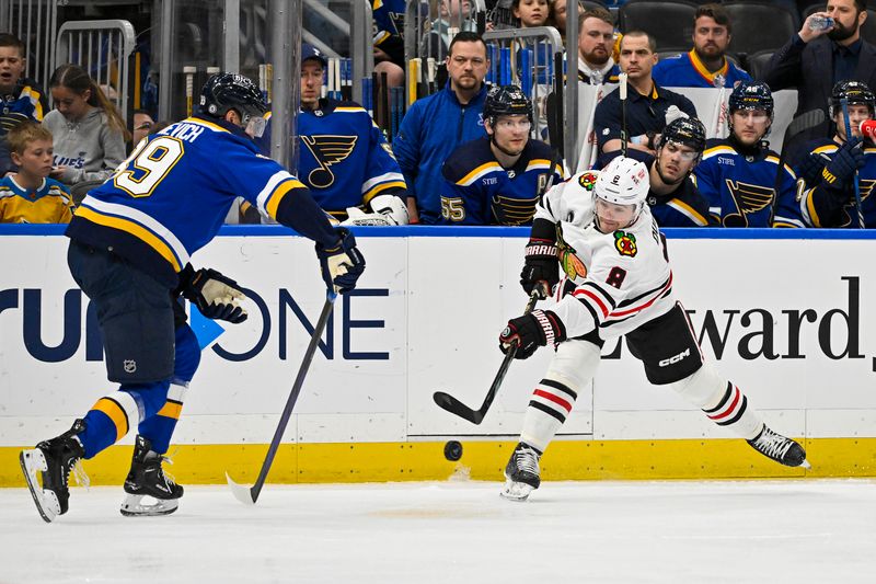 Apr 10, 2024; St. Louis, Missouri, USA;  Chicago Blackhawks center Ryan Donato (8) shoots as St. Louis Blues left wing Pavel Buchnevich (89) defends during the first period at Enterprise Center. Mandatory Credit: Jeff Curry-USA TODAY Sports