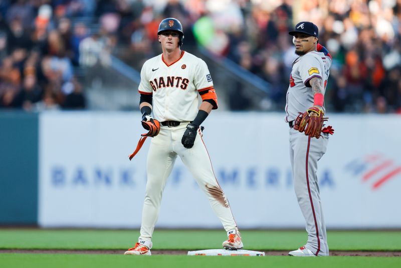 Aug 12, 2024; San Francisco, California, USA; San Francisco Giants shortstop Tyler Fitzgerald (49) reaches second base on an error by Atlanta Braves outfielder Ramón Laureano (18) during the first inning at Oracle Park. Mandatory Credit: Sergio Estrada-USA TODAY Sports