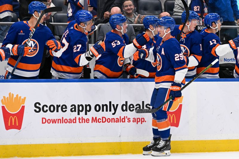 Oct 26, 2024; Elmont, New York, USA;  New York Islanders center Brock Nelson (29) celebrates his goal with the New York Islanders bench against the Florida Panthers during the first period at UBS Arena. Mandatory Credit: Dennis Schneidler-Imagn Images