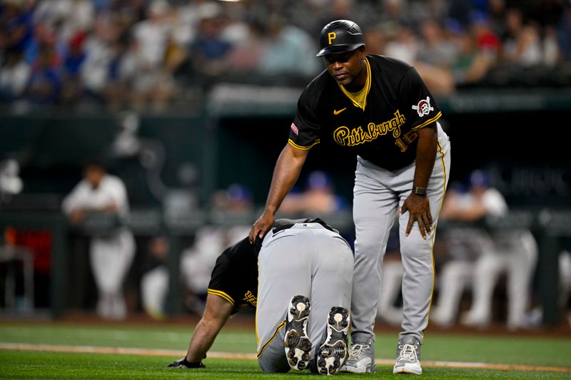 Aug 21, 2024; Arlington, Texas, USA; Pittsburgh Pirates first base coach Tarrik Brock (16) checks on designated hitter Joey Bart (14) after Bart is hit by a pitch during the game against the Texas Rangers at Globe Life Field. Mandatory Credit: Jerome Miron-USA TODAY Sports