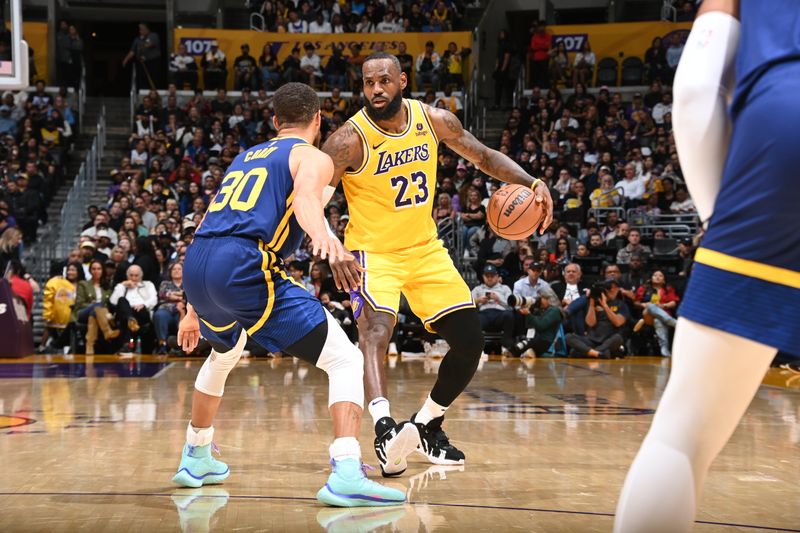 LOS ANGELES, CA - APRIL 9: LeBron James #23 of the Los Angeles Lakers dribbles the ball during the game against the Golden State Warriors on April 9, 2024 at Crypto.Com Arena in Los Angeles, California. NOTE TO USER: User expressly acknowledges and agrees that, by downloading and/or using this Photograph, user is consenting to the terms and conditions of the Getty Images License Agreement. Mandatory Copyright Notice: Copyright 2024 NBAE (Photo by Andrew D. Bernstein/NBAE via Getty Images)