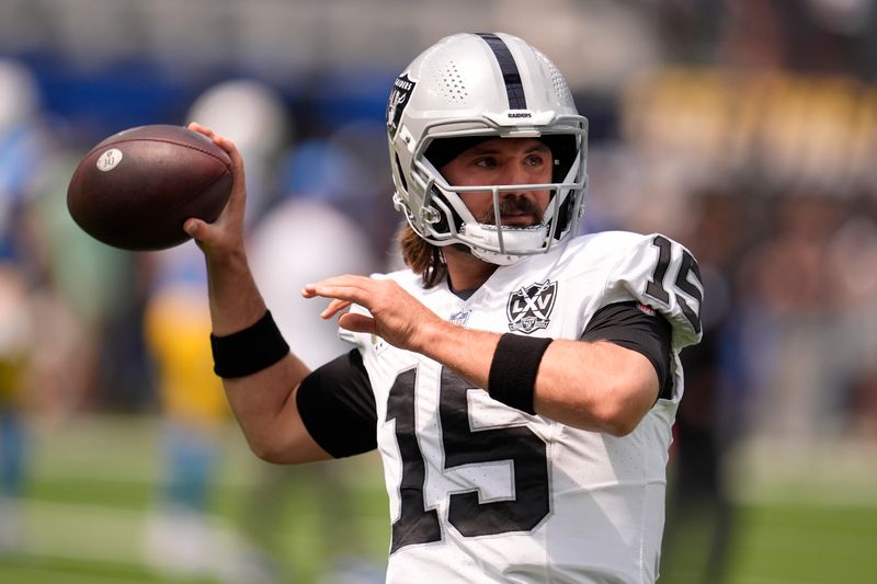 Las Vegas Raiders quarterback Gardner Minshew II (15) warms up before an NFL football game against the Los Angeles Chargers, Sunday, Sept. 8, 2024, in Inglewood, Calif. (AP Photo/Marcio Jose Sanchez)