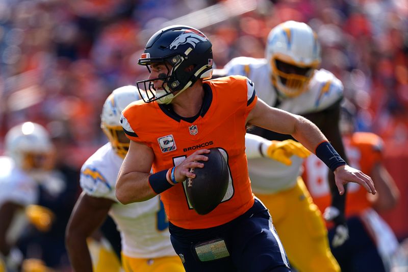 Denver Broncos quarterback Bo Nix (10) scrambles during the first half of an NFL football game against the Los Angeles Chargers, Sunday, Oct. 13, 2024, in Denver. (AP Photo/David Zalubowski)