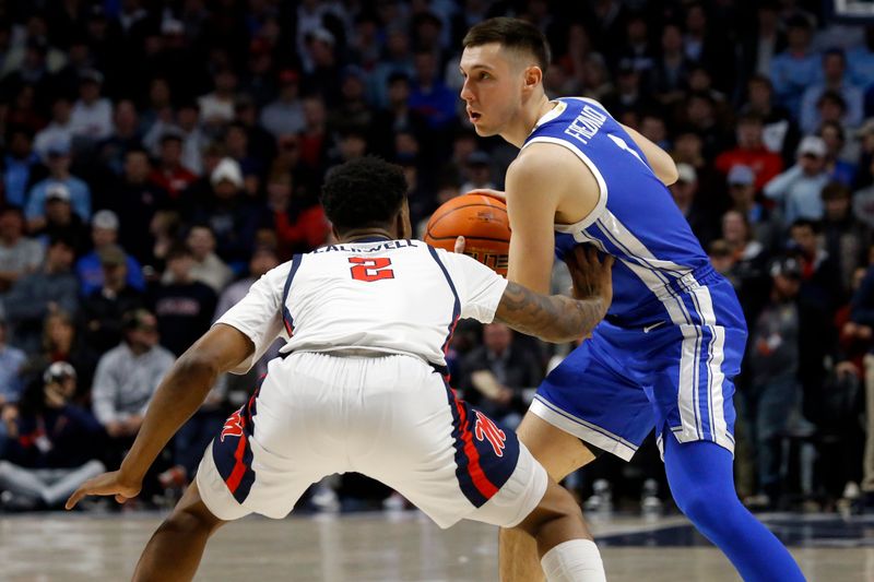 Jan 31, 2023; Oxford, Mississippi, USA; Kentucky Wildcats guard CJ Fredrick (1) controls the ball as Mississippi Rebels guard TJ Caldwell (2) defends during the first half at The Sandy and John Black Pavilion at Ole Miss. Mandatory Credit: Petre Thomas-USA TODAY Sports