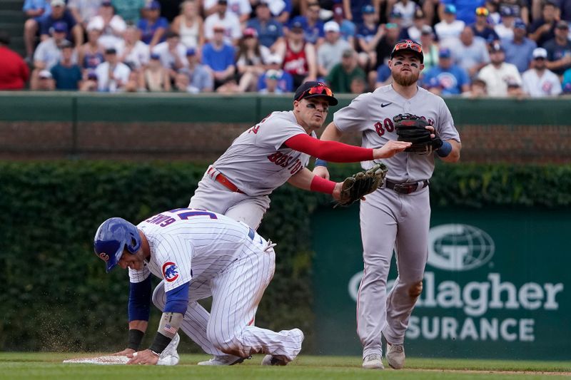 Jul 15, 2023; Chicago, Illinois, USA; Boston Red Sox shortstop Enrique Hernandez (5) forces out Chicago Cubs catcher Yan Gomes (15) at second base during the third inning at Wrigley Field. Mandatory Credit: David Banks-USA TODAY Sports