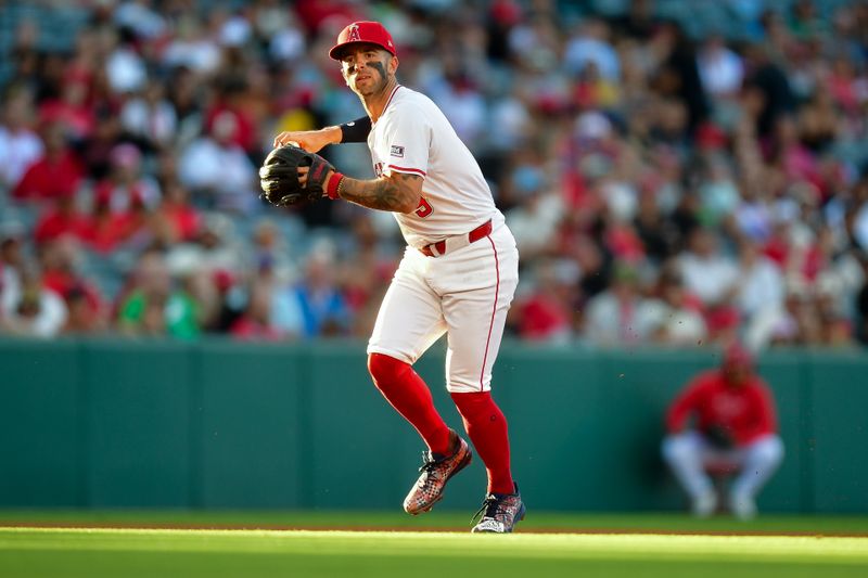 Jun 25, 2024; Anaheim, California, USA; Los Angeles Angels shortstop Zach Neto (9) throws to first for the out against Oakland Athletics catcher Shea Langeliers (23) during the third inning at Angel Stadium. Mandatory Credit: Gary A. Vasquez-USA TODAY Sports