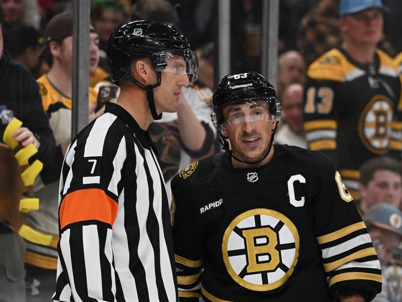 Oct 14, 2023; Boston, Massachusetts, USA; Boston Bruins left wing Brad Marchand (63) talks with referee Garrett Rank (7) during the second period of a game against the Nashville Predators at the TD Garden. Mandatory Credit: Brian Fluharty-USA TODAY Sports