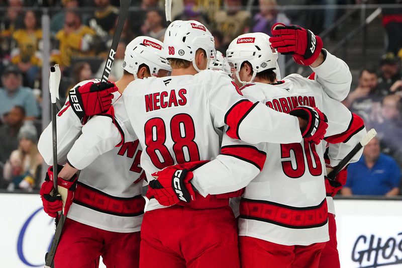 Nov 11, 2024; Las Vegas, Nevada, USA; Carolina Hurricanes left wing Eric Robinson (50) celebrates with teammates after scoring a goal against the Vegas Golden Knights during the first period at T-Mobile Arena. Mandatory Credit: Stephen R. Sylvanie-Imagn Images