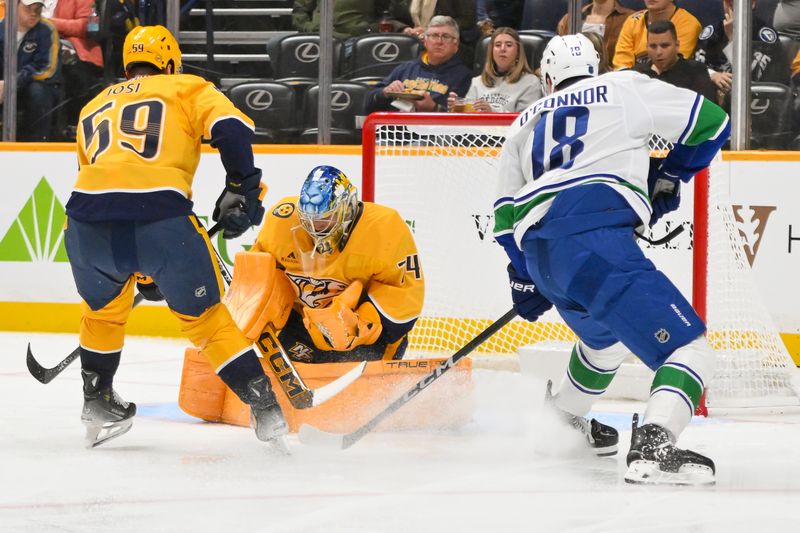 Oct 23, 2025; Nashville, Tennessee, USA;  Nashville Predators goaltender Juuse Saros (74) blocks the shot of Vancouver Canucks left wing Drew O'Connor (18) during the second period at Bridgestone Arena. Mandatory Credit: Steve Roberts-Imagn Images