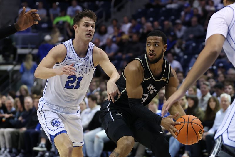 Feb 13, 2024; Provo, Utah, USA; Central Florida Knights guard Darius Johnson (3) looks to pass the ball against Brigham Young Cougars guard Trevin Knell (21) during the first half at Marriott Center. Mandatory Credit: Rob Gray-USA TODAY Sports