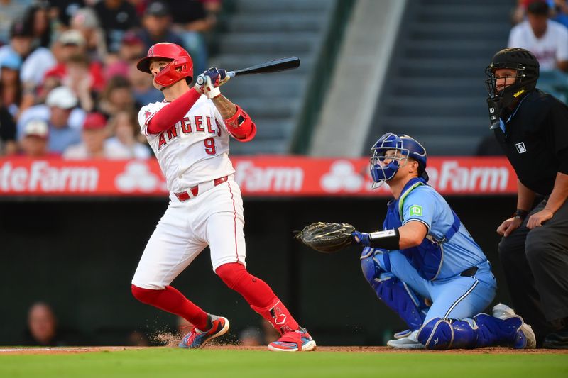 Aug 13, 2024; Anaheim, California, USA; Los Angeles Angels shortstop Zach Neto (9) hits a single against the Toronto Blue Jays during the first inning at Angel Stadium. Mandatory Credit: Gary A. Vasquez-USA TODAY Sports