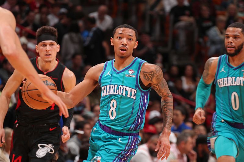 MIAMI, FL - JANUARY 14: Nick Smith Jr. #8 of the Charlotte Hornets brings the ball up court against the Miami Heat on January 14, 2024 at Kaseya Center in Miami, Florida. NOTE TO USER: User expressly acknowledges and agrees that, by downloading and or using this Photograph, user is consenting to the terms and conditions of the Getty Images License Agreement. Mandatory Copyright Notice: Copyright 2024 NBAE (Photo by Issac Baldizon/NBAE via Getty Images)