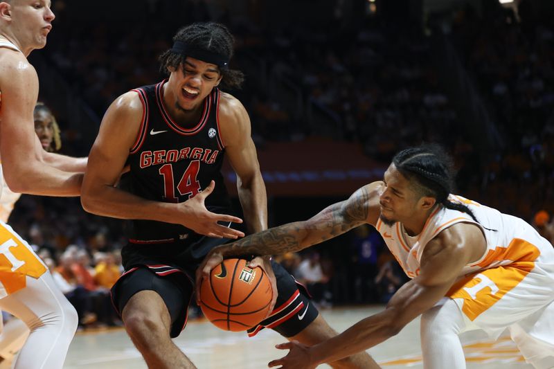 Jan 15, 2025; Knoxville, Tennessee, USA; Tennessee Volunteers guard Zakai Zeigler (5) steals the ball from Georgia Bulldogs forward Asa Newell (14) during the second half at Thompson-Boling Arena at Food City Center. Mandatory Credit: Randy Sartin-Imagn Images