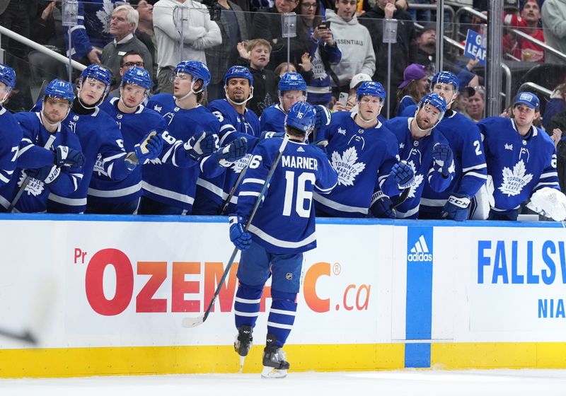 Apr 13, 2024; Toronto, Ontario, CAN; Toronto Maple Leafs right wing Mitch Marner (16) celebrates at the bench after scoring a goal during the first period against the Detroit Red Wings at Scotiabank Arena. Mandatory Credit: Nick Turchiaro-USA TODAY Sports