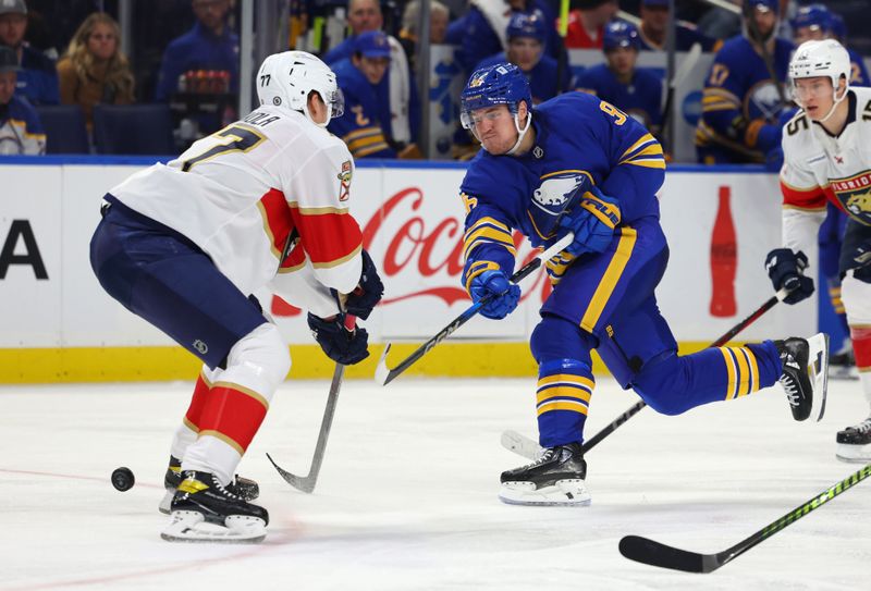 Oct 28, 2024; Buffalo, New York, USA;  Florida Panthers defenseman Niko Mikkola (77) tries to block a shot by Buffalo Sabres right wing Nicolas Aube-Kubel (96) during the second period at KeyBank Center. Mandatory Credit: Timothy T. Ludwig-Imagn Images