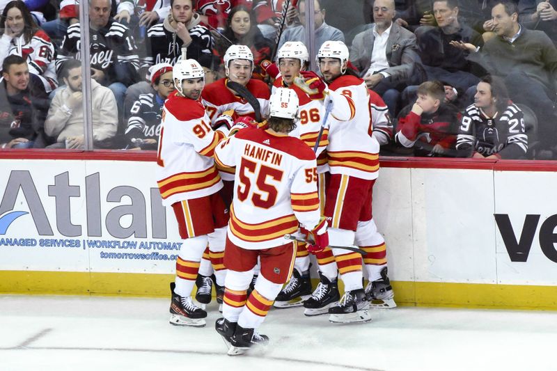 Feb 8, 2024; Newark, New Jersey, USA; Calgary Flames left wing Andrei Kuzmenko (96) celebrates with teammates after scoring a goal against the New Jersey Devils during the third period at Prudential Center. Mandatory Credit: John Jones-USA TODAY Sports