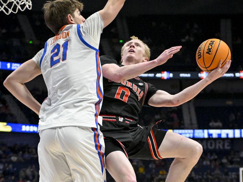 Mar 14, 2024; Nashville, TN, USA;  Georgia Bulldogs guard Blue Cain (0) shoots over Florida Gators forward Alex Condon (21) during the first half at Bridgestone Arena. Mandatory Credit: Steve Roberts-USA TODAY Sports