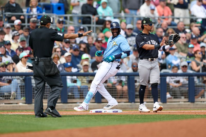 Mar 17, 2026; Port Charlotte, Florida, USA; Tampa Bay Rays designated hitter Yandy Diaz (2) runs into third base against the New York Yankees in the third inning during spring training at Charlotte Sports Park. Mandatory Credit: Nathan Ray Seebeck-Imagn Images