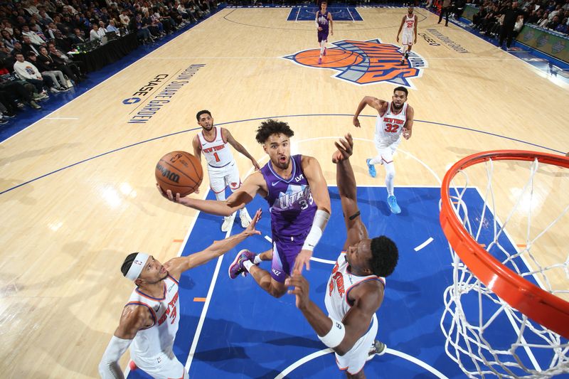 NEW YORK, NY - JANUARY 1:  Johnny Juzang #33 of the Utah Jazz drives to the basket during the game against the New York Knicks on January 1, 2025 at Madison Square Garden in New York City, New York.  NOTE TO USER: User expressly acknowledges and agrees that, by downloading and or using this photograph, User is consenting to the terms and conditions of the Getty Images License Agreement. Mandatory Copyright Notice: Copyright 2025 NBAE  (Photo by Nathaniel S. Butler/NBAE via Getty Images)