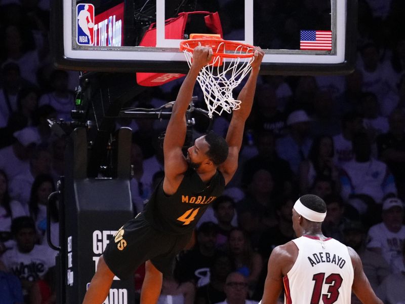 MIAMI, FLORIDA - APRIL 26: Evan Mobley #4 of the Cleveland Cavaliers dunks the ball against Bam Adebayo #13 of the Miami Heat during the fourth quarter in Game Three of the Eastern Conference First Round NBA Playoffs at Kaseya Center on April 26, 2025 in Miami, Florida. NOTE TO USER: User expressly acknowledges and agrees that, by downloading and or using this photograph, User is consenting to the terms and conditions of the Getty Images License Agreement. (Photo by Rich Storry/Getty Images)