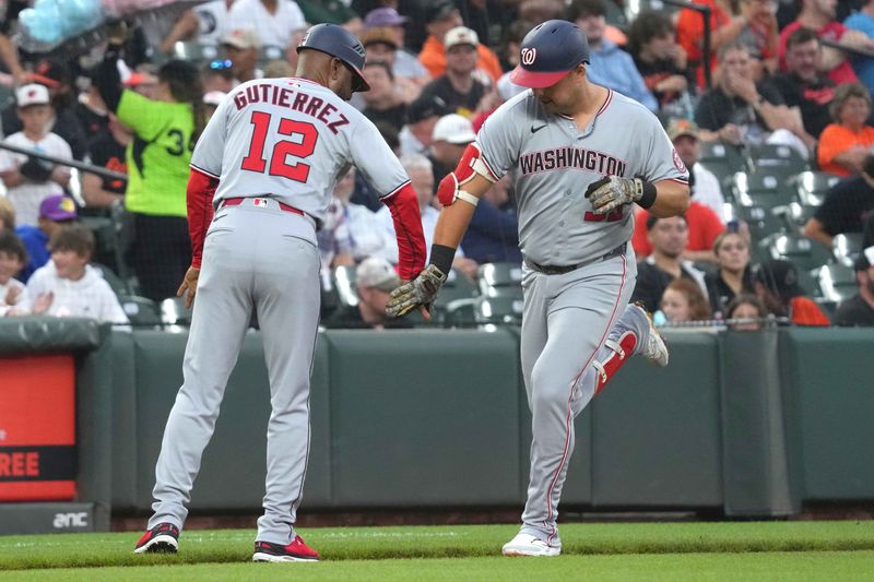 May 16, 2025; Baltimore, Maryland, USA; Washington Nationals first baseman Nathaniel Lowe (33) greeted by coach Ricky Gutierrez (12) following his solo home run in the second inning against the Baltimore Orioles at Oriole Park at Camden Yards. Mandatory Credit: Mitch Stringer-Imagn Images