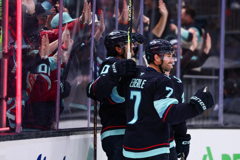 Dec 10, 2025; Seattle, Washington, USA; Seattle Kraken right wing Jordan Eberle (7) celebrates a goal scored by center Matty Beniers (10) in the third period against the Los Angeles Kings  at Climate Pledge Arena. Mandatory Credit: Kevin Ng-Imagn Images