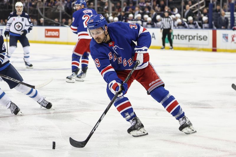 Nov 12, 2024; New York, New York, USA;  New York Rangers center Sam Carrick (39) chases the puck in the third period against the Winnipeg Jets at Madison Square Garden. Mandatory Credit: Wendell Cruz-Imagn Images