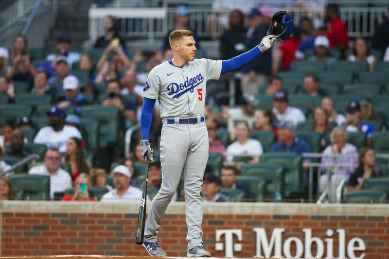 Sep 13, 2024; Atlanta, Georgia, USA; Los Angeles Dodgers first baseman Freddie Freeman (5) acknowledges the crowd before an at bat against the Atlanta Braves in the first inning at Truist Park. Mandatory Credit: Brett Davis-Imagn Images