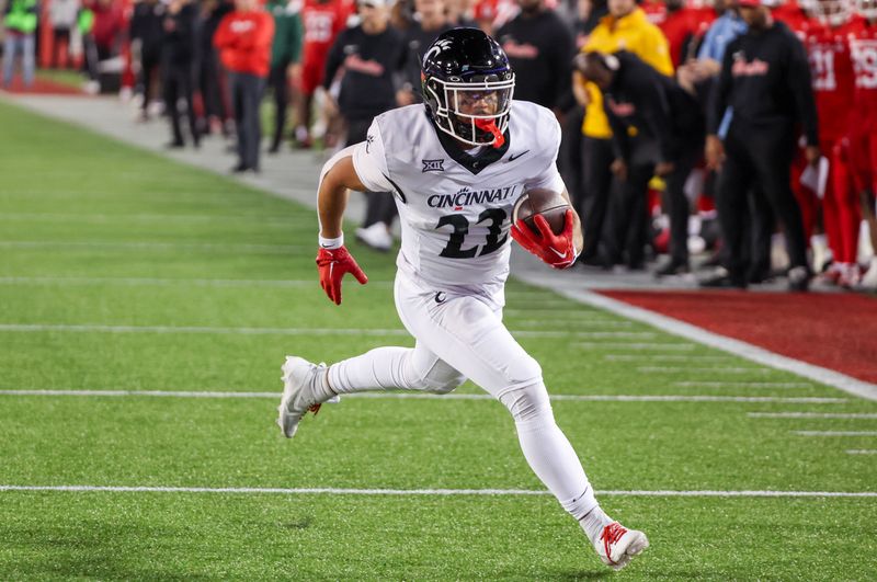 Nov 11, 2023; Houston, Texas, USA; Cincinnati Bearcats running back Ryan Montgomery (22) rushes for a touchdown against the Houston Cougars in the first half at TDECU Stadium. Mandatory Credit: Thomas Shea-USA TODAY Sports