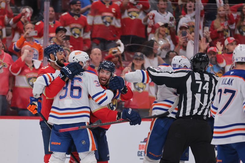 Jun 9, 2025; Sunrise, Florida, USA; Edmonton Oilers defenseman John Klingberg (36) and Florida Panthers forward Evan Rodrigues (17) react after the third period in game three of the 2025 Stanley Cup Final at Amerant Bank Arena. Mandatory Credit: Sam Navarro-Imagn Images