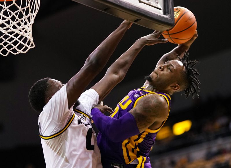 Feb 1, 2023; Columbia, Missouri, USA; LSU Tigers guard Trae Hannibal (0) goes up for a dunk against Missouri Tigers forward Mohamed Diarra (0) during the second half at Mizzou Arena. Mandatory Credit: Jay Biggerstaff-USA TODAY Sports