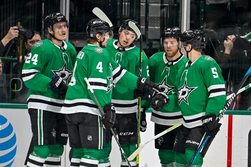 Apr 9, 2024; Dallas, Texas, USA; Dallas Stars defenseman Miro Heiskanen (4) and center Roope Hintz (24) and left wing Jason Robertson (21) and center Joe Pavelski (16) and defenseman Nils Lundkvist (5) celebrates a goal scored by Robertson against the Buffalo Sabres during the first period at the American Airlines Center. Mandatory Credit: Jerome Miron-USA TODAY Sports