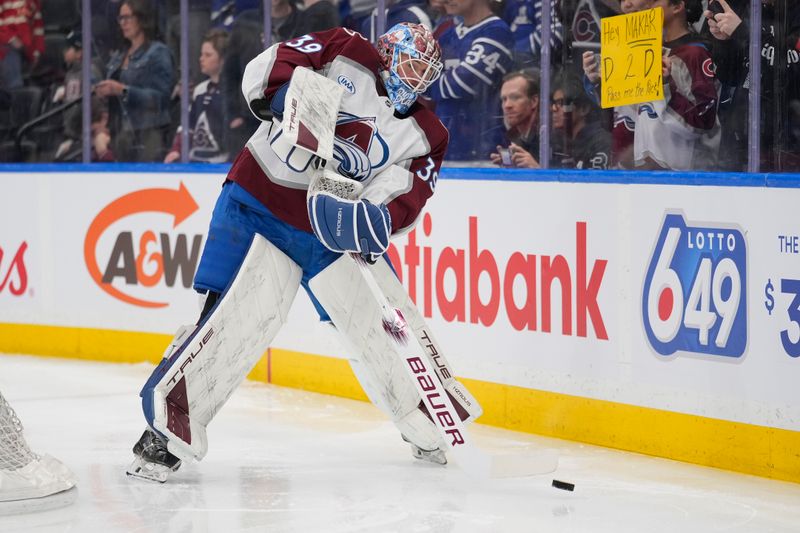 Mar 19, 2025; Toronto, Ontario, CAN; Colorado Avalanche goaltender Mackenzie Blackwood (39) clears the puck during during warm up before a game against the Toronto Maple Leafs at Scotiabank Arena. Mandatory Credit: John E. Sokolowski-Imagn Images