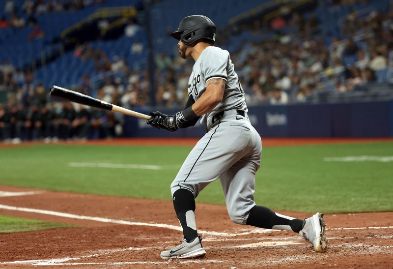 May 8, 2024; St. Petersburg, Florida, USA;  Chicago White Sox shortstop Paul DeJong (29) singles against the Tampa Bay Rays during the fifth inning at Tropicana Field. Mandatory Credit: Kim Klement Neitzel-USA TODAY Sports