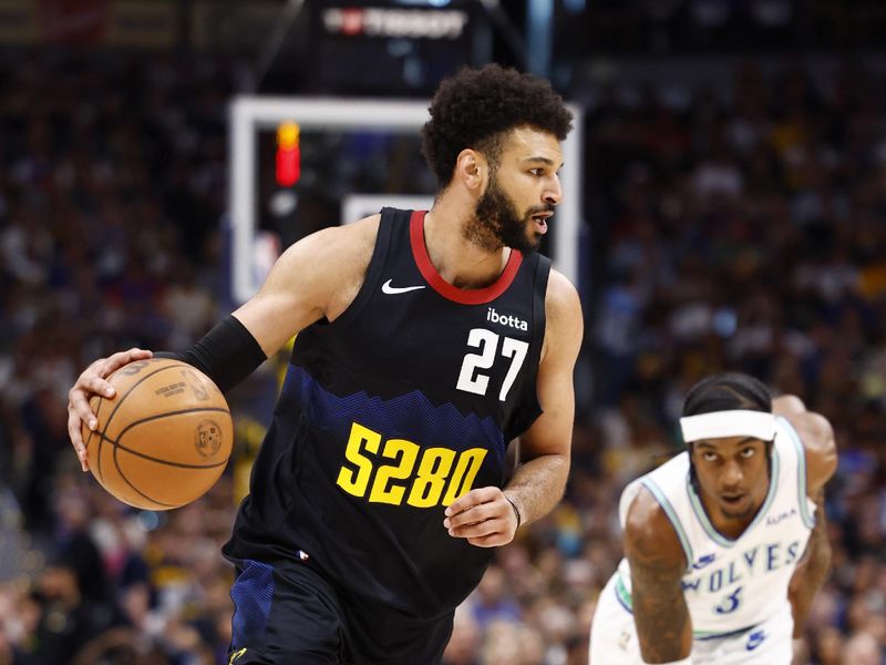 DENVER, COLORADO - MAY 19: Jamal Murray #27 of the Denver Nuggets drives to the basket against Jaden McDaniels #3 of the Minnesota Timberwolves during the first quarter in Game Seven of the Western Conference Second Round Playoffs at Ball Arena on May 19, 2024 in Denver, Colorado. NOTE TO USER: User expressly acknowledges and agrees that, by downloading and or using this photograph, User is consenting to the terms and conditions of the Getty Images License Agreement. (Photo by C. Morgan Engel/Getty Images)