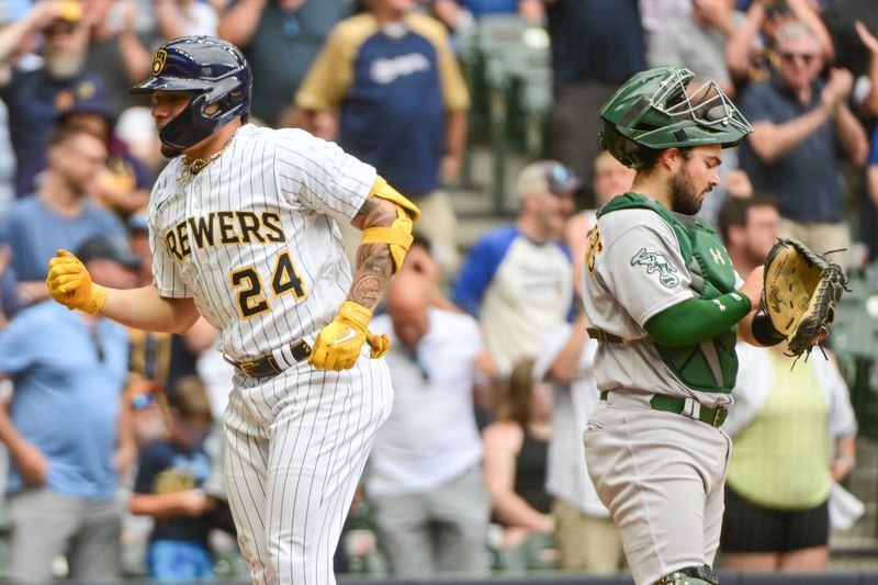 Jun 10, 2023; Milwaukee, Wisconsin, USA;  Milwaukee Brewers catcher William Contreras (24) reacts after hitting a solo home run as Oakland Athletics catcher Shea Langeliers (23) looks on in the eighth inning at American Family Field. Mandatory Credit: Benny Sieu-USA TODAY Sports