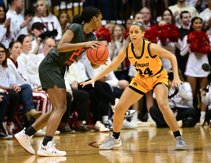 Feb 22, 2024; Bloomington, Indiana, USA; Indiana Hoosiers guard Chloe Moore-McNeil (22) looks to get the ball past Iowa Hawkeyes guard Gabbie Marshall (24) during the first half at Simon Skjodt Assembly Hall. Mandatory Credit: Marc Lebryk-USA TODAY Sports