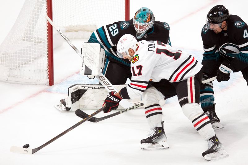 Oct 31, 2024; San Jose, California, USA; Chicago Blackhawks left winger Nick Foligno (17) reaches for the puck in front of San Jose Sharks goaltender Mackenzie Blackwood (29) during the third period at SAP Center at San Jose. Mandatory Credit: D. Ross Cameron-Imagn Images