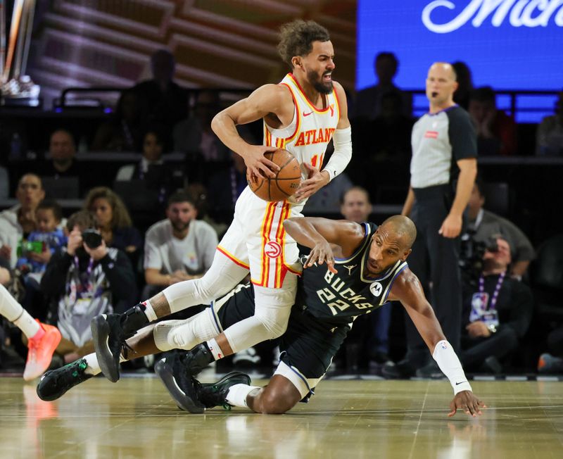 LAS VEGAS, NEVADA - DECEMBER 14: Khris Middleton #22 of the Milwaukee Bucks fouls Trae Young #11 of the Atlanta Hawks in the first half of a semifinal game of the Emirates NBA Cup at T-Mobile Arena on December 14, 2024 in Las Vegas, Nevada. NOTE TO USER: User expressly acknowledges and agrees that, by downloading and or using this photograph, User is consenting to the terms and conditions of the Getty Images License Agreement. (Photo by Ethan Miller/Getty Images)