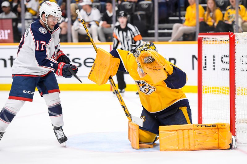 Apr 13, 2024; Nashville, Tennessee, USA; Nashville Predators goaltender Juuse Saros (74) blocks the puck against the Columbus Blue Jackets during the second period at Bridgestone Arena. Mandatory Credit: Steve Roberts-USA TODAY Sports