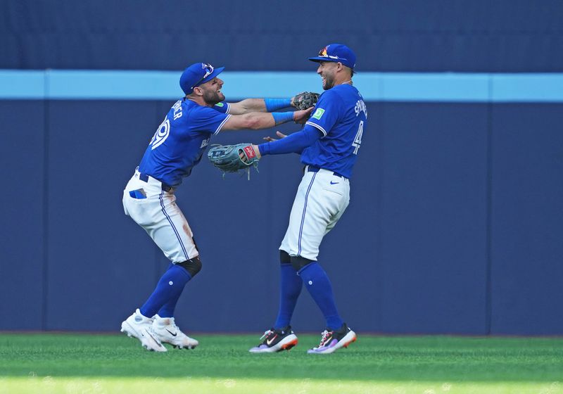 May 20, 2024; Toronto, Ontario, CAN; Toronto Blue Jays centre fielder Kevin Kiermaier (39) catches a fly ball for the final out and celebrates the win with right fielder George Springer (4) against the Chicago White Sox during the ninth inning at Rogers Centre. Mandatory Credit: Nick Turchiaro-USA TODAY Sports