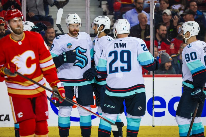 Mar 4, 2024; Calgary, Alberta, CAN; Seattle Kraken defenseman Adam Larsson (6) celebrates his goal with teammates against the Calgary Flames during the third period at Scotiabank Saddledome. Mandatory Credit: Sergei Belski-USA TODAY Sports