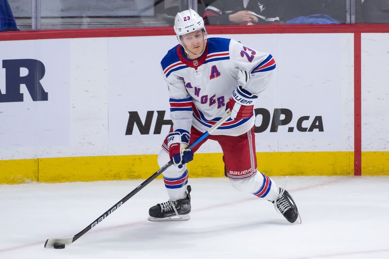 Jan 27, 2024; Ottawa, Ontario, CAN; New York Rangers defenseman Adam Fox (23) controls the puck in the third period against the Ottawa Senators at the Canadian Tire Centre. Mandatory Credit: Marc DesRosiers-USA TODAY Sports