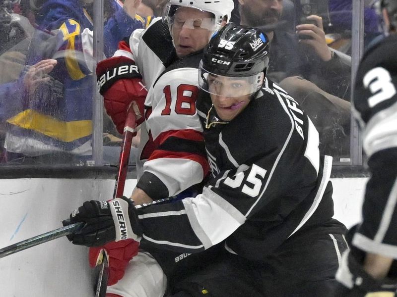 Mar 3, 2024; Los Angeles, California, USA; New Jersey Devils left wing Ondrej Palat (18) and Los Angeles Kings right wing Quinton Byfield (55) clash along the boards in the first period at Crypto.com Arena. Mandatory Credit: Jayne Kamin-Oncea-USA TODAY Sports