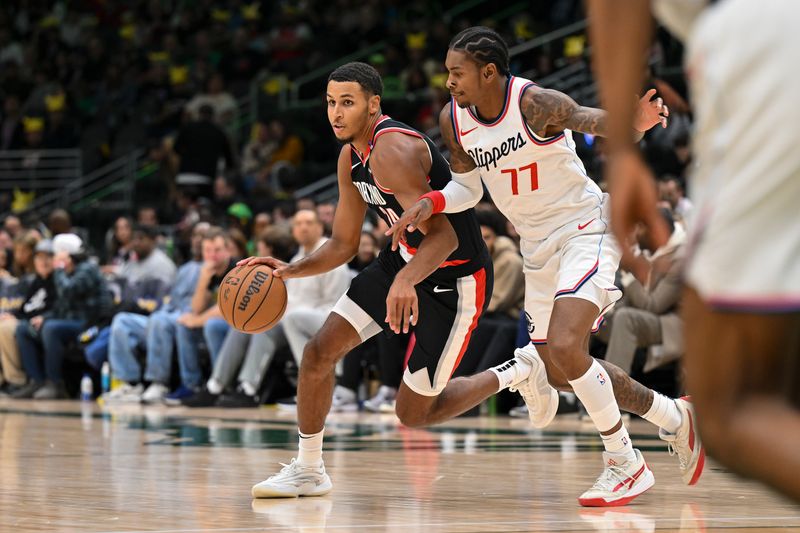 SEATTLE, WASHINGTON - OCTOBER 11: Kris Murray #24 of the Portland Trail Blazers dribbles against Kevin Porter Jr. #77 of the LA Clippers during the third quarter of the Rain City Showcase game at Climate Pledge Arena on October 11, 2024 in Seattle, Washington. The LA Clippers won 101-99. NOTE TO USER: User expressly acknowledges and agrees that, by downloading and or using this photograph, User is consenting to the terms and conditions of the Getty Images License Agreement. (Photo by Alika Jenner/Getty Images)