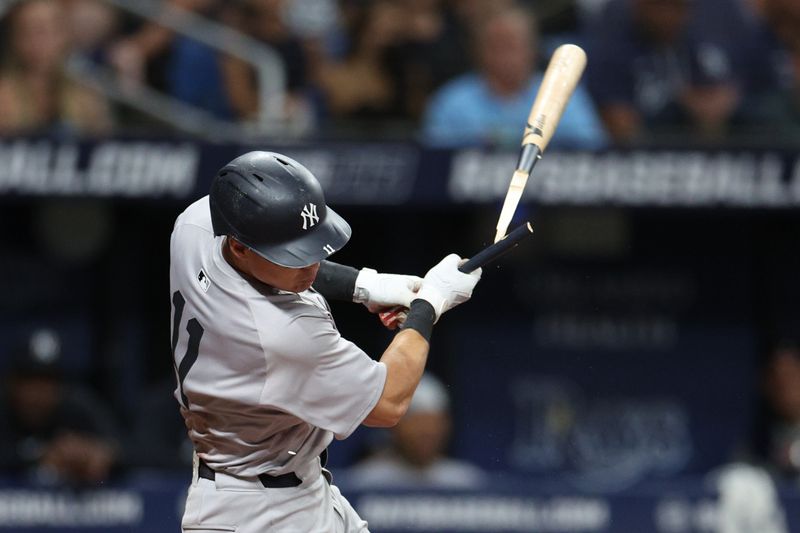 Jul 10, 2024; St. Petersburg, Florida, USA; New York Yankees shortstop Anthony Volpe (11) breaks his bat on a ground ball against the Tampa Bay Rays in the sixth inning  at Tropicana Field. Mandatory Credit: Nathan Ray Seebeck-USA TODAY Sports