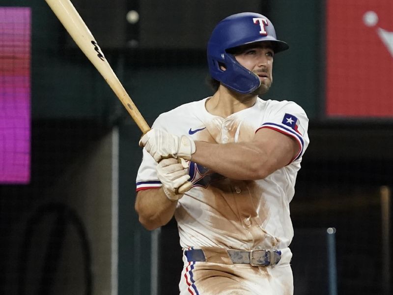 Apr 25, 2024; Arlington, Texas, USA; Texas Rangers third baseman Josh Smith (8) follows through on a solo home run during the fourth inning against the Seattle Mariners at Globe Life Field. Mandatory Credit: Raymond Carlin III-USA TODAY Sports